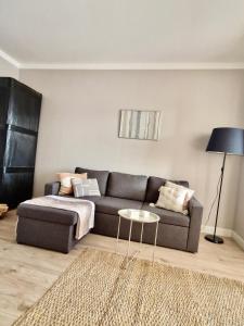 a living room with a couch and a table at Tolstoi Scandinavian 1 bedroom apartment + free parking in Tartu