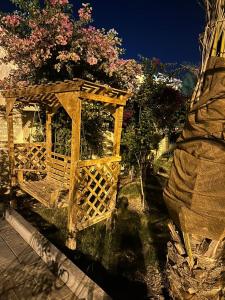 una estructura de madera con flores encima en luule, en Al Ain