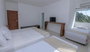 Postel nebo postele na pokoji v ubytování Pousada Recanto dos Pássaros - Arraial d'Ajuda