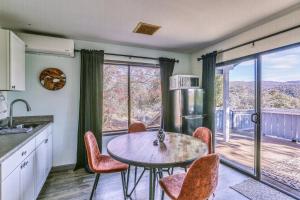 a kitchen with a table and chairs and a balcony at Cozy Studio with Well-Being Retreat Near Yosemite! in Ahwahnee