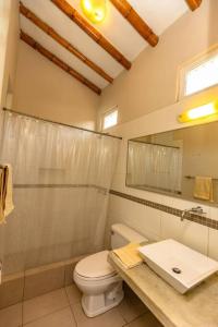 a bathroom with a toilet and a sink at Casa Luz De Luna-MANCORA in Máncora