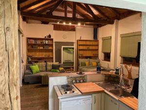 a kitchen and living room with a couch in the background at Süße Wohnung Privatvermieter in Schwaz