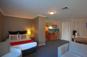 a hotel room with two beds and a television at Quest Waterfront in Hobart
