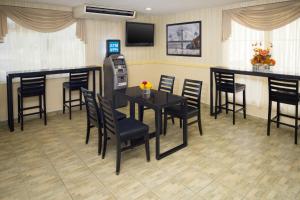 a restaurant with a cash register and a table and chairs at Skyview Motel in Fort Lee