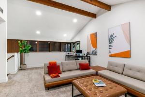 a living room with a couch and a table at Mid-Century-Modern Airport Home in Sacramento