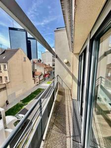 a balcony of a building with a view of a street at Magnificent apartment Paris Bagnolet 302 in Bagnolet