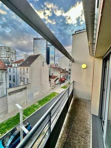 a balcony of a building with a view of a city at Magnificent apartment Paris Bagnolet 302 in Bagnolet