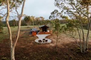 a group of three dogs sitting in front of a cabin at Akuna Estate - Luxury Glamping Experience in Excelsior