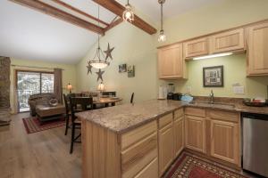 a kitchen with wooden cabinets and a dining room at Beaver Village Unit #0232R in Winter Park