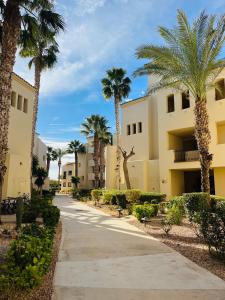 a street in front of a building with palm trees at Casa André - 3 Bedroom Roda Golf apartment nearby entrance and clubhouse in Roda