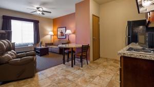a kitchen and living room with a table and a couch at Best Western North Edge Inn in Dodge City