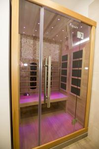 a walk in shower in a room with purple lighting at Holiday Home EB with Heated Pool in Gata