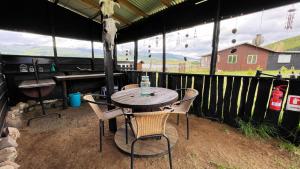 a table and chairs in a tent with a view at Cabaña - Granja Lago Frío in Coihaique