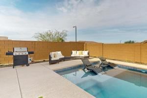 a backyard with a swimming pool with a couch and chairs at Phoenix Star - Main House in Phoenix