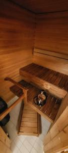 an inside view of a sauna with a pot on the floor at Upea saunallinen asunto järvinäkymällä. in Jyväskylä