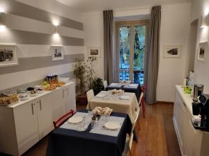a room with two tables and a kitchen with a counter at I Reali Bed & Breakfast in Turin