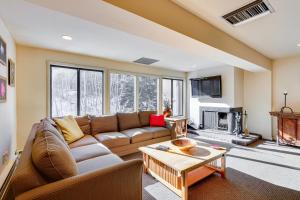 a living room with a couch and a fireplace at Condo Near Golf Club about 2 Mi to Vail Ski Resort! in Vail