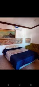 a bedroom with a large bed with a blue blanket at Departamento Kassandra in Puerto Peñasco