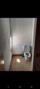 a small bathroom with a toilet in a stall at Departamento Kassandra in Puerto Peñasco