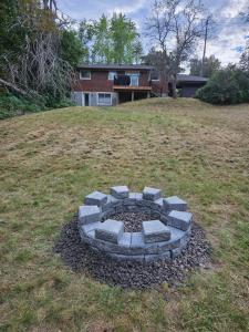 een vuurplaats in de tuin van een huis bij Games BBQ with a upgraded stay near kawartha in Lakefield