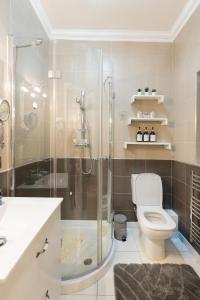a bathroom with a shower and a toilet and a sink at The Nautical Nook in Marsaxlokk