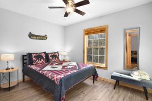 a bedroom with a bed and a ceiling fan at Tsaliwood Cabin in Sevierville
