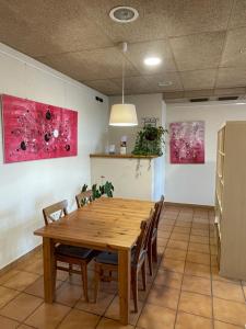 a dining room with a wooden table and chairs at Hotel Font del Pla in La Jonquera