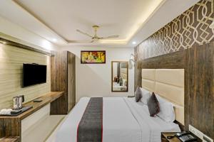 a hotel room with a bed and a tv at The Nirvana Delhi Airport in New Delhi