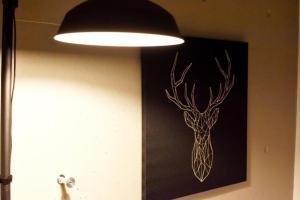 a light hanging on a wall with a picture of a deer at Ethos Ebisu 201 - Vacation STAY 09298v in Tokyo