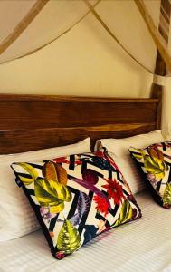 a bed with two pillows on top of it at Swallow villa - French guest house in Ahangama