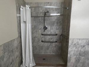a shower with a shower curtain in a bathroom at Super 8 by Wyndham Brookshire TX in Brookshire +33 photos