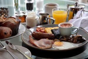 a plate of breakfast food on a table at The Ullswater Inn- The Inn Collection Group in Glenridding