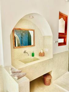 a bathroom with a sink and a mirror at Swallow villa - French guest house in Ahangama