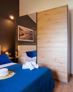 a bedroom with two beds and a large wooden wall at Villa Carilù in Altavilla Milicia