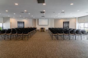 a room with chairs and a screen in a room at Hotel Jose Antonio in Lima