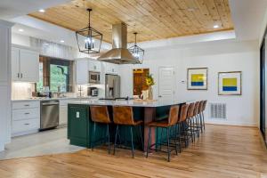 a kitchen with a large island with bar stools at Majestic Manor in Blue Ridge