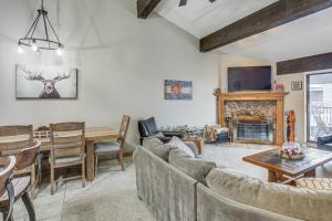 a living room with a couch and a table at Colorado Escape w/ Pool Access & Mountain Views! in Avon