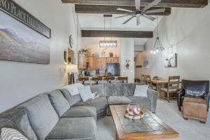 a living room with a couch and a table at Colorado Escape w/ Pool Access & Mountain Views! in Avon