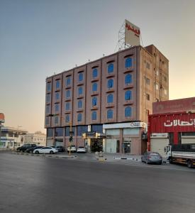 a large building on the corner of a street at Al Anoud & Aljawhara Apartments in Hafr Al-Batin