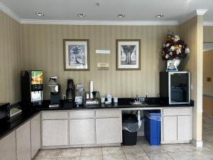 a coffee shop with a counter in a hotel room at Super 8 by Wyndham Brookshire TX in Brookshire