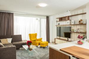 a living room with a couch and a table at Forest Park Garden Apartment in Bratislava