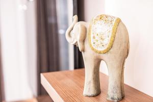 a figurine of an elephant sitting on a table at Forest Park Garden Apartment in Bratislava