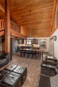 a living room with wooden ceilings and a dining room at Cranberry in Valemount
