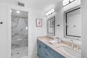a white bathroom with two sinks and a shower at The Rest at Potomac Farms in Ashburn +48 photos