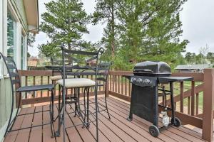 a grill and stools on a deck with a grill at Mountain View Duplex / Walk to main street in Woodland Park