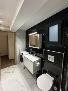a bathroom with a white toilet and a sink at ICON Urban Living Trikala in Tríkala +50 photos