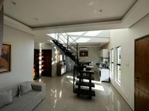 a living room with a staircase in a house at Puerta del Lago in San Bernardino