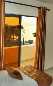 a bedroom with a window with a view of the ocean at PALM BEACH HOTEL free ticket for pedal boat تذكرة مجانية للالعاب البحرية in Aqaba