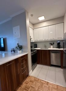 a kitchen with wooden cabinets and a counter top at Hello,CRESCENT in Montréal