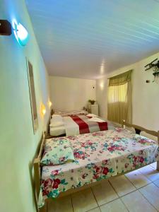 a bedroom with two beds in a room at Pousada Elpirata Sidney in Ceará-Mirim